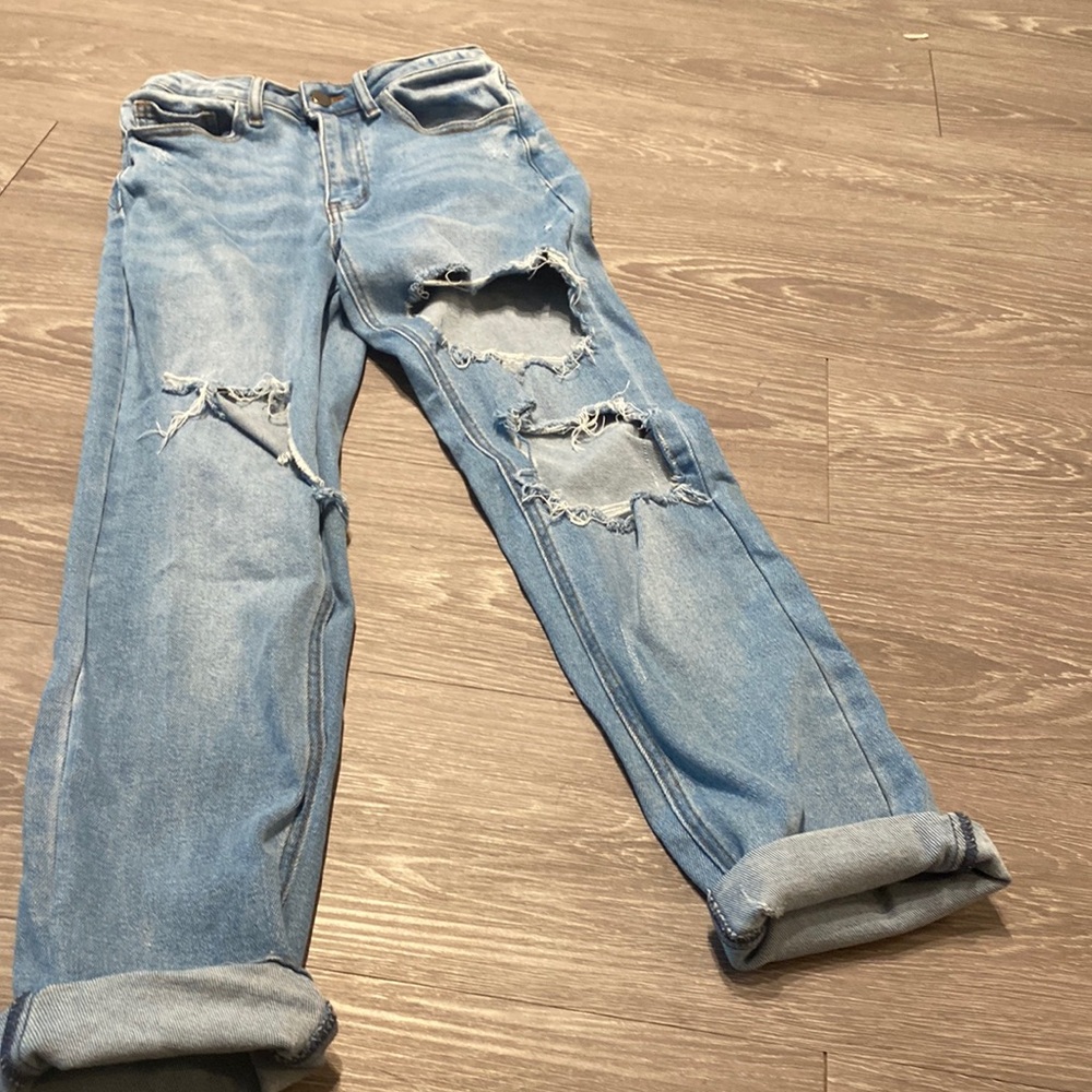 Distressed high waisted jeans, medium wash, rips in back.